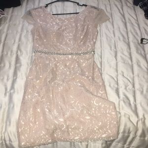 Light pink, open back mini dress.